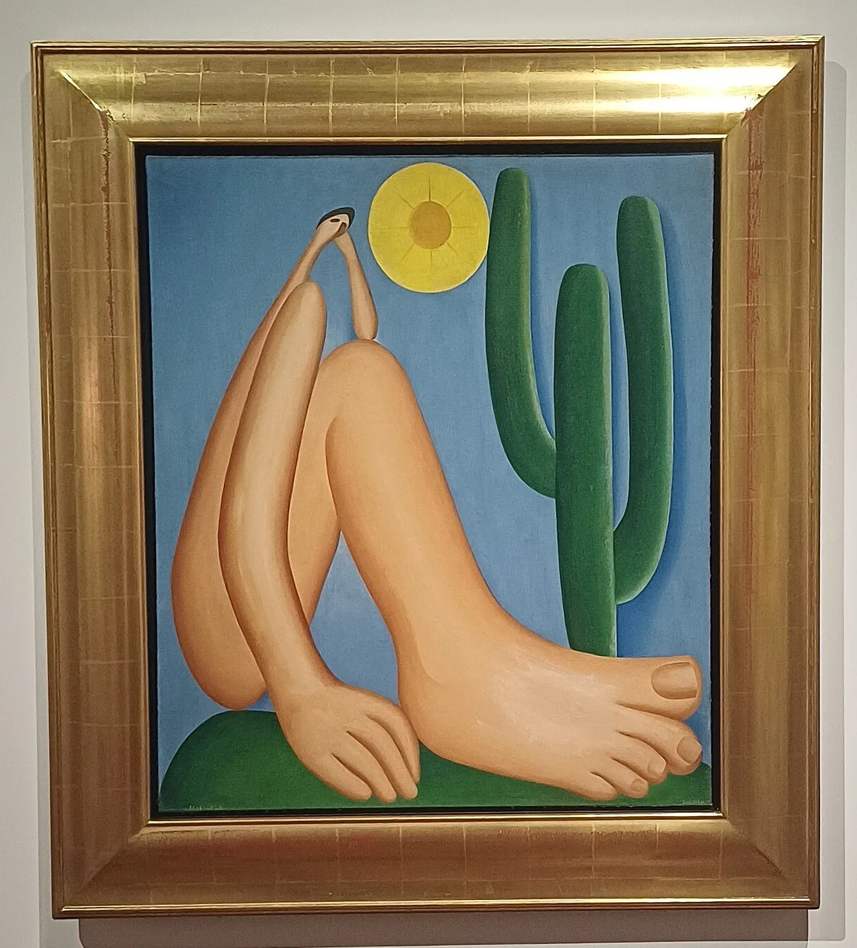 Abaporu, oil painting by Tarsila do Amaral, 1928: a seated figure with an enormous foot beside a green cactus under a yellow sun, in a gilt frame - MALBA collection